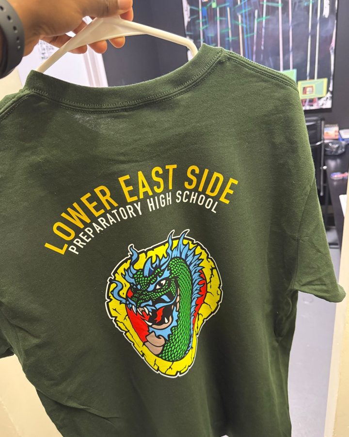 A green t-shirt with a full-color school dragon on the back