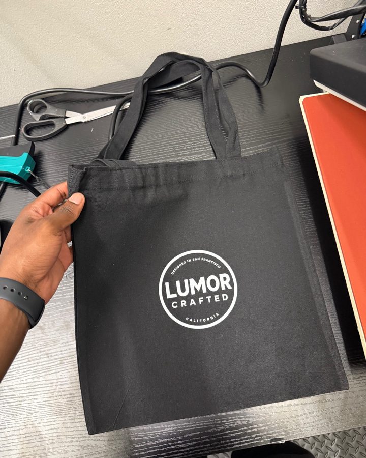 A black tote with a one-color white logo